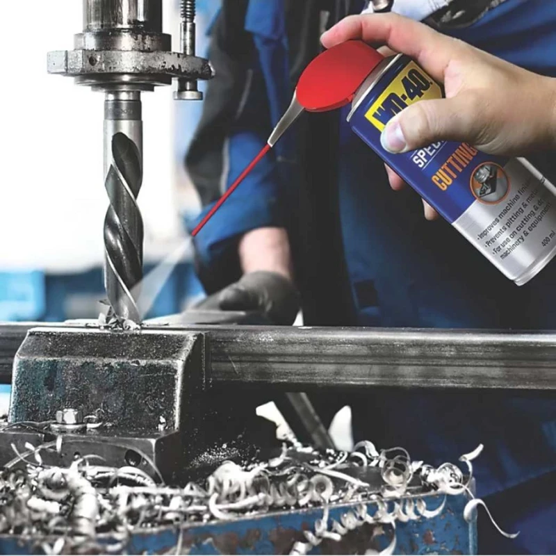 Person using WD40 Specialist Multi-Purpose Cutting Oil Spray on a metal drill bit.
