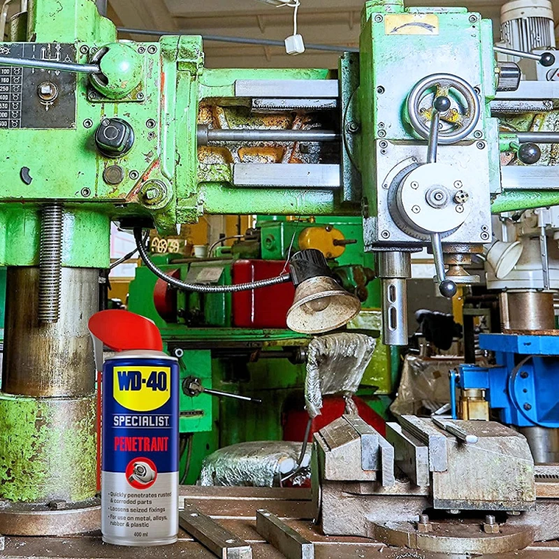 WD-40 Specialist Penetrant Fast Release Penetrating Oil can in a workshop setting with machinery.