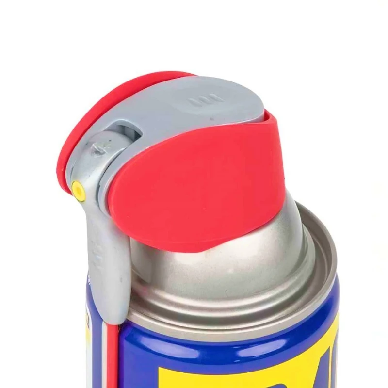 Close-up of the top of a WD40 silicone spray can with a red and grey nozzle.