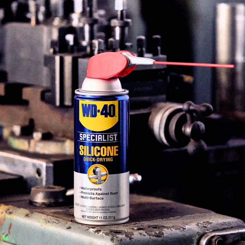 WD40 Specialist High-Performance Silicone Spray 400ml can with applicator in an industrial setting.