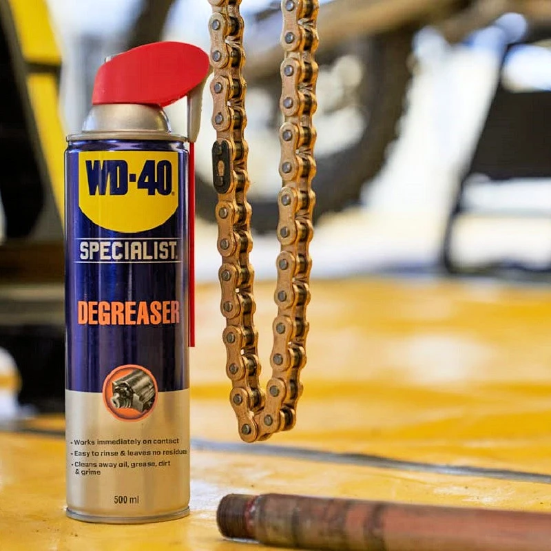 WD40 Specialist Industrial Strength Degreaser Spray 500ml next to a metal chain on a workshop floor.