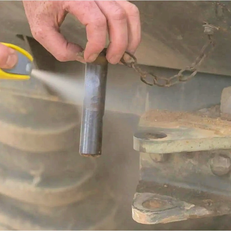Person spraying WD40 white lithium grease on a metal part.