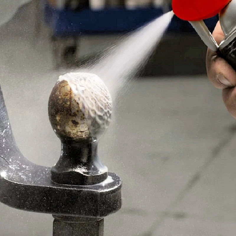 Spraying white lithium grease onto a metal ball joint using WD40 Specialist Spray.