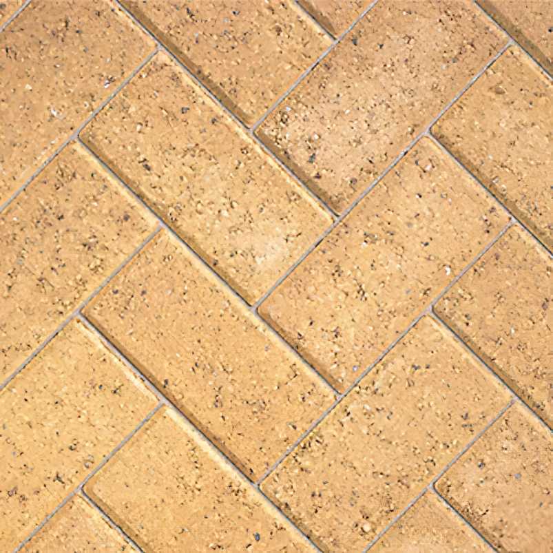 Close-up of a herringbone block paving layout in light brown tones, suitable for sand jointing