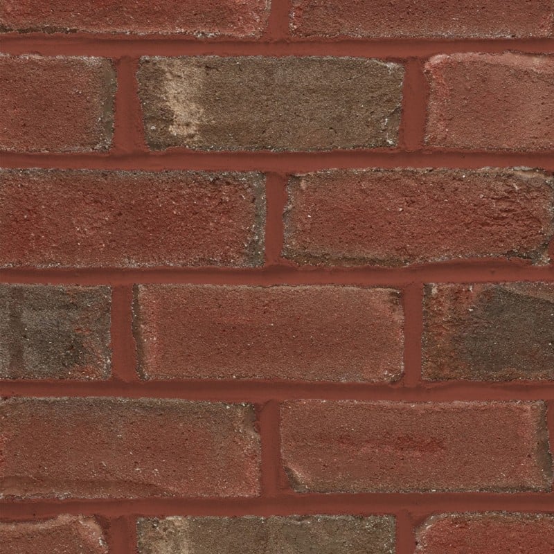 Textured red brick wall with red mortar joints