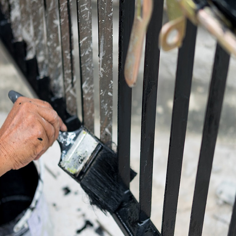 Sika 901 Black Jack Bitumen Paint being applied to black wrought iron railings