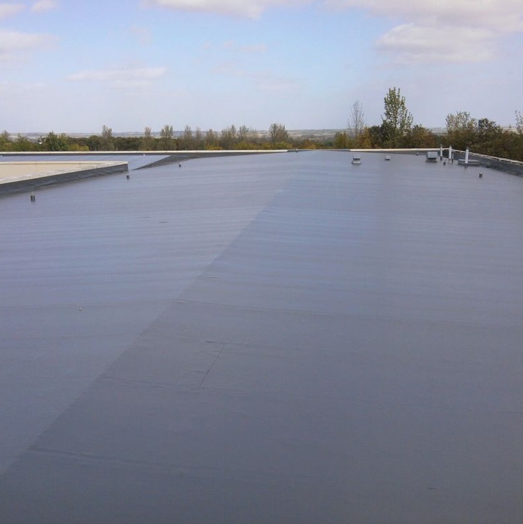 Finished flat roof surface coated with Sika Black Jack 905 All Weather Roof Coating
