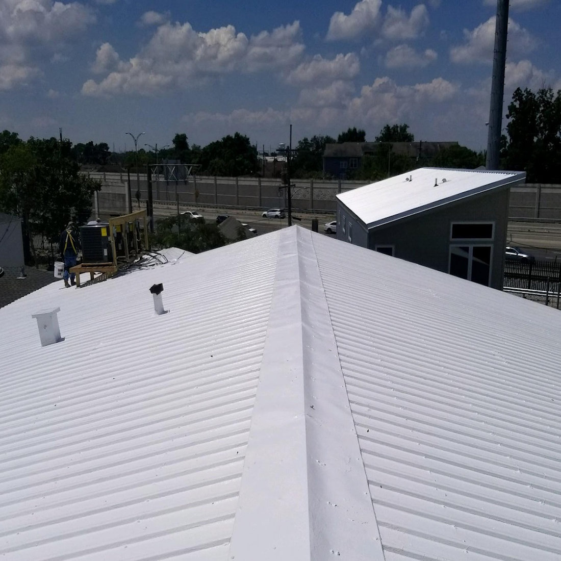 Pitched metal roof coated with Sika Black Jack 907 Solar Reflective Paint