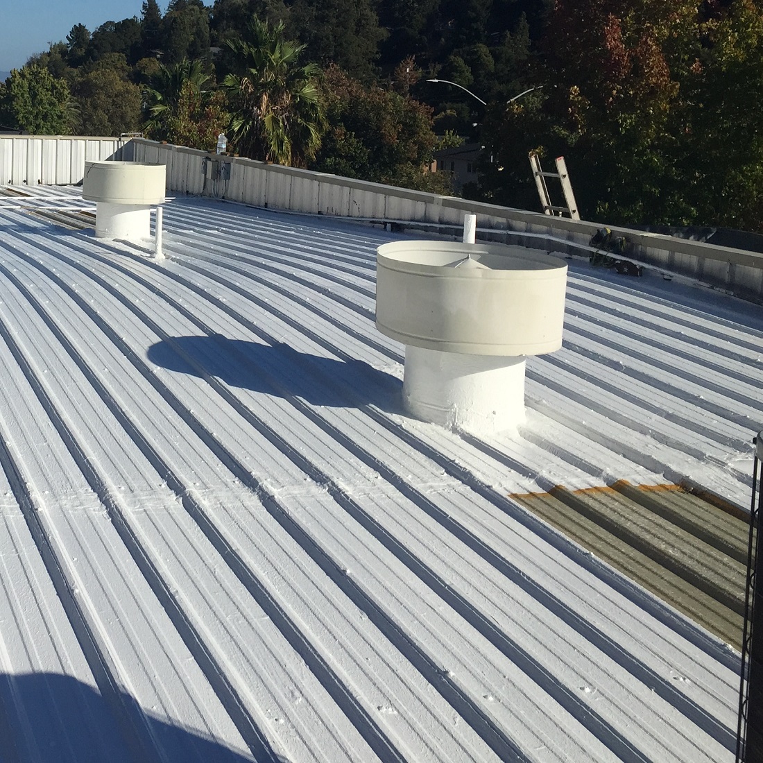 Metal roof coated with Sika Black Jack 907 Solar Reflective Paint
