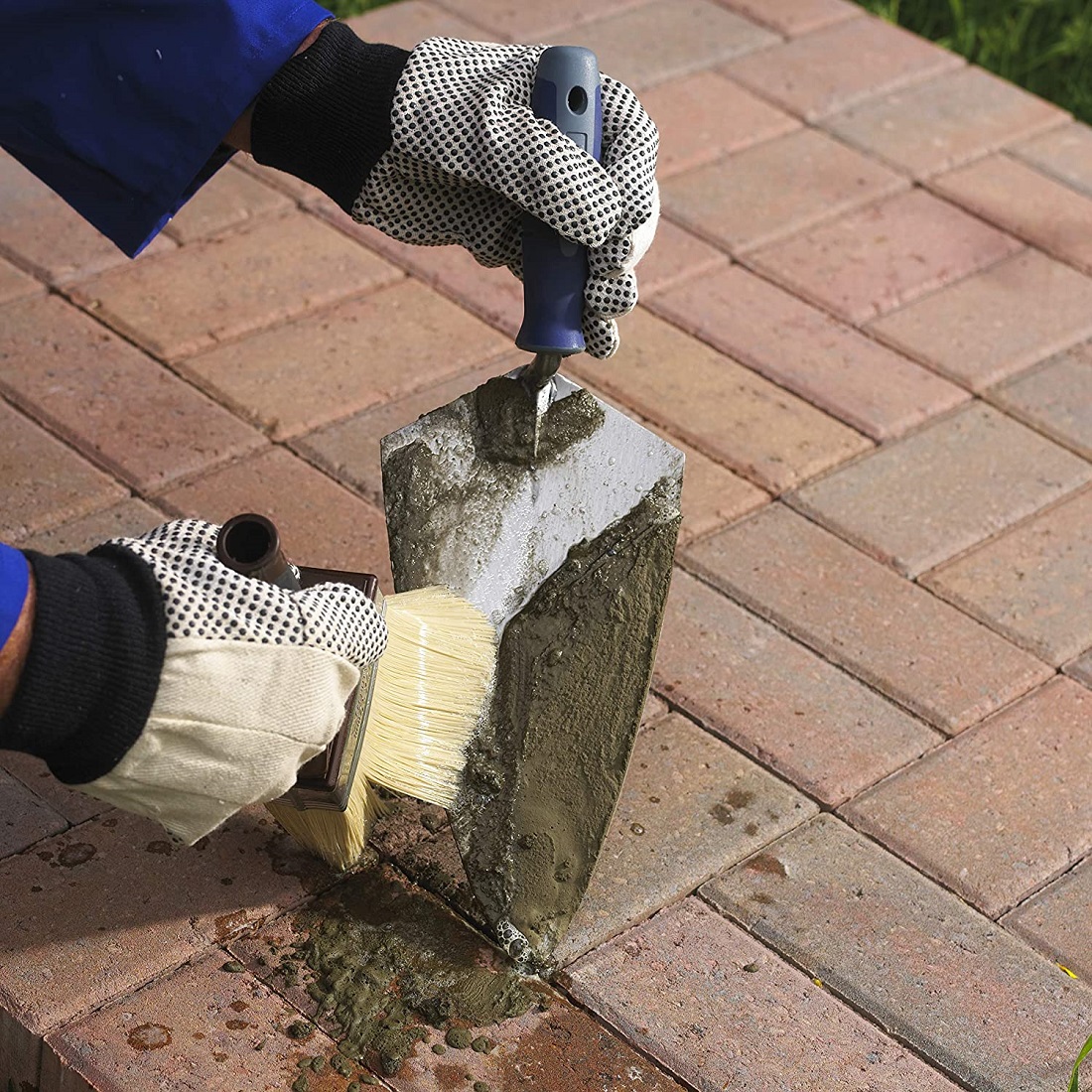 Cleaning cement residue from trowel using brush and solution during masonry tool maintenance