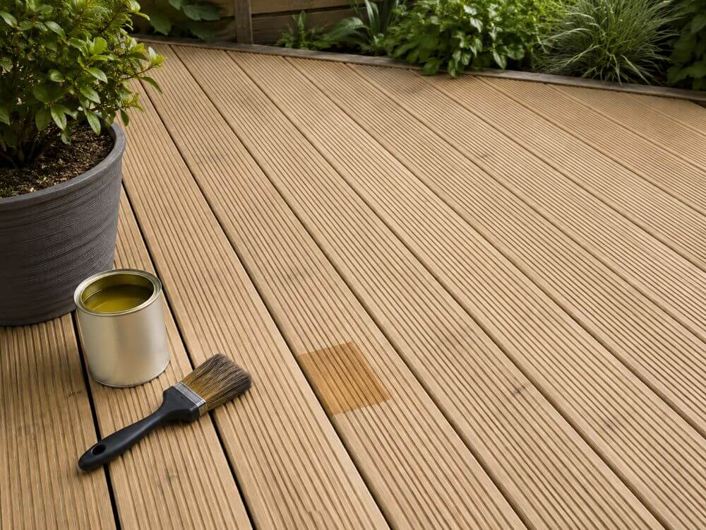 Checking dry timber decking before applying decking treatment