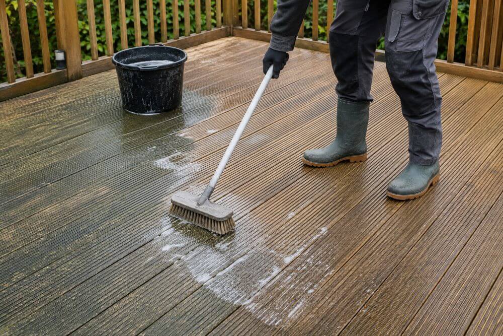Cleaning dirty timber decking boards before applying decking treatment