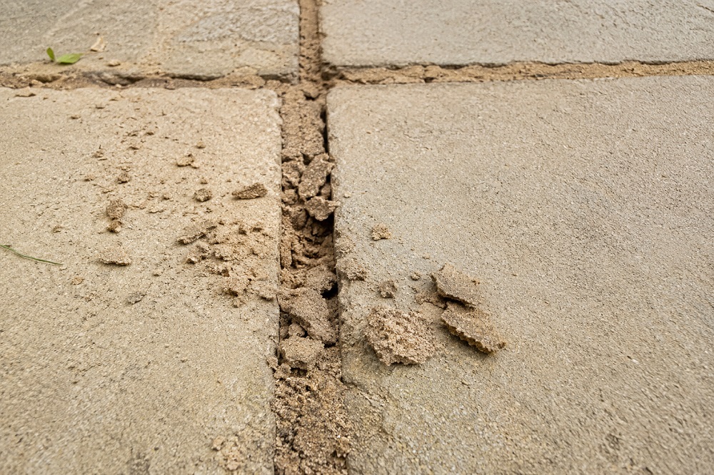 Loose failed patio jointing compound that should be removed before re-jointing