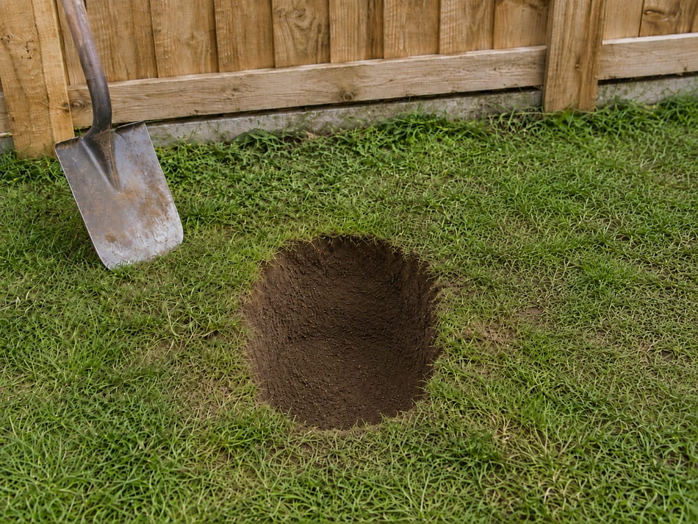 Prepared fence post hole dug to allow concrete around the post