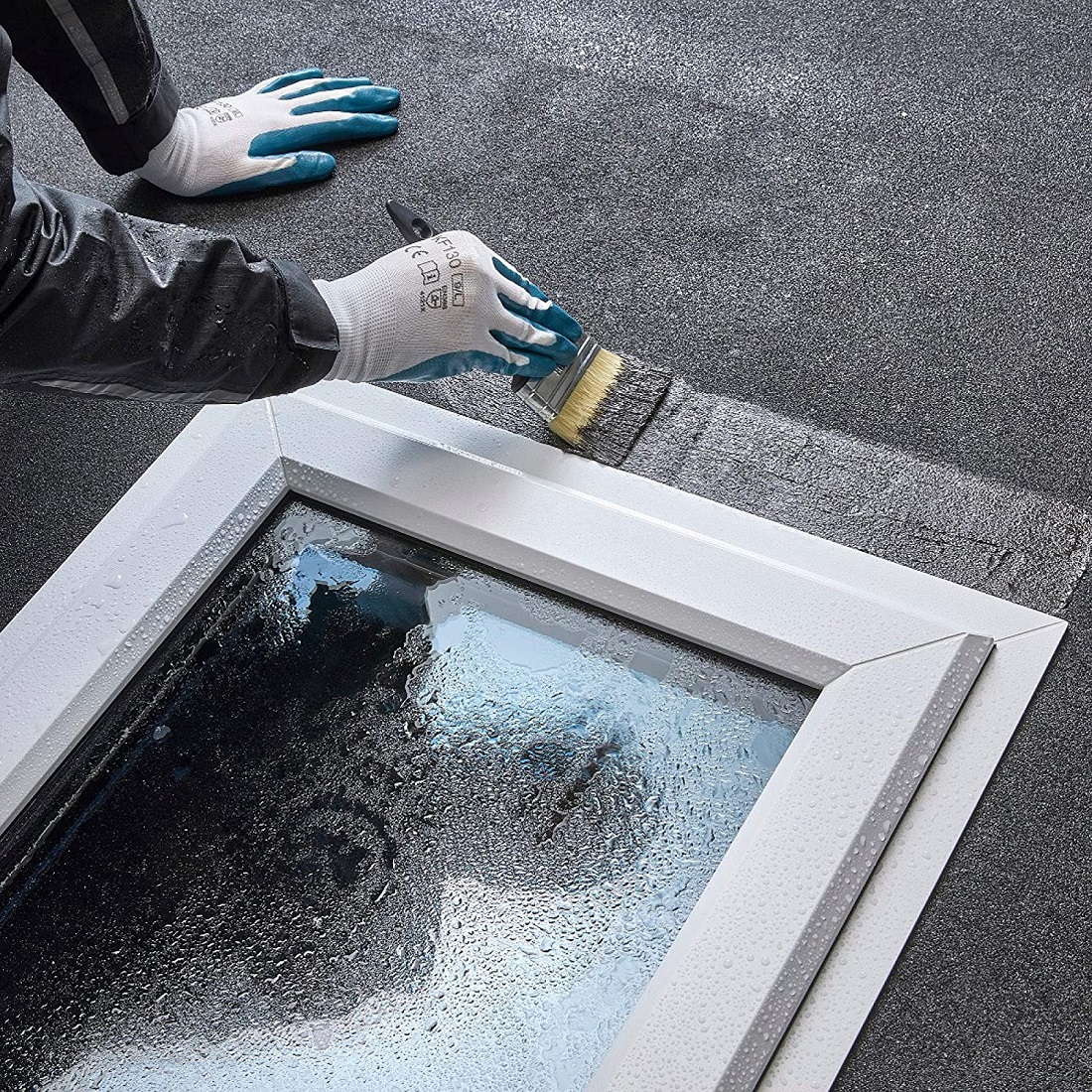 Sika Evercryl roof repair compound being brush applied around a rooflight