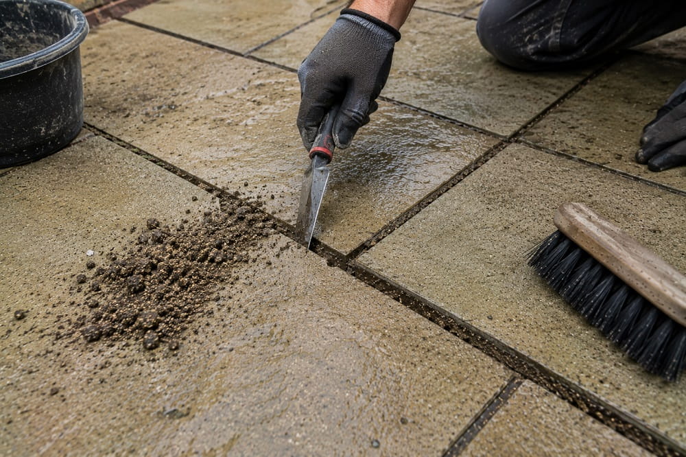 Removing failed patio jointing compound before re-jointing paving slabs