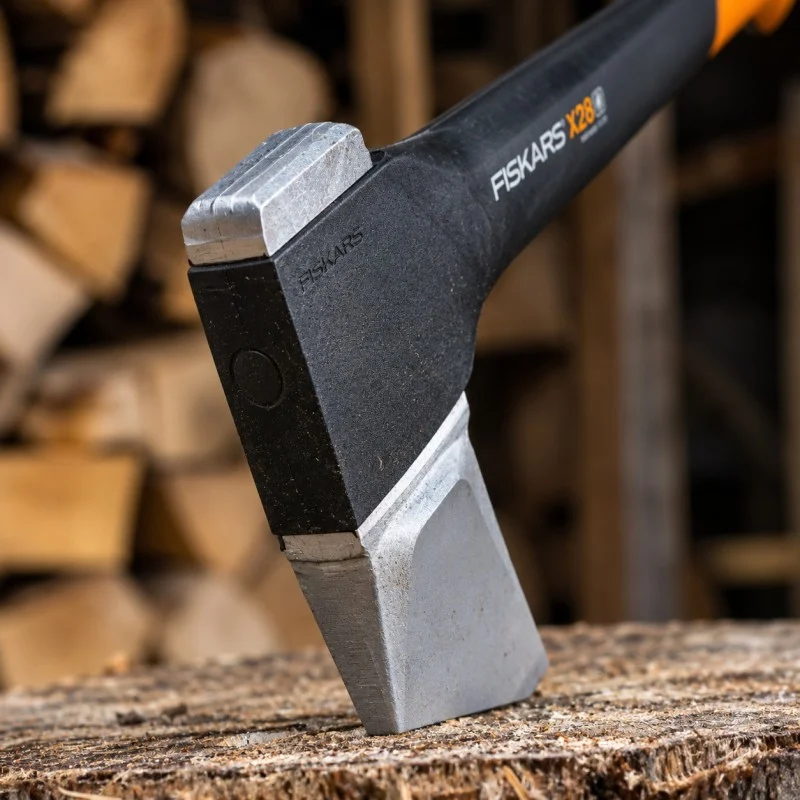 Close-up of a Fiskars splitting axe head showing its wedge shape and silver cutting edge.