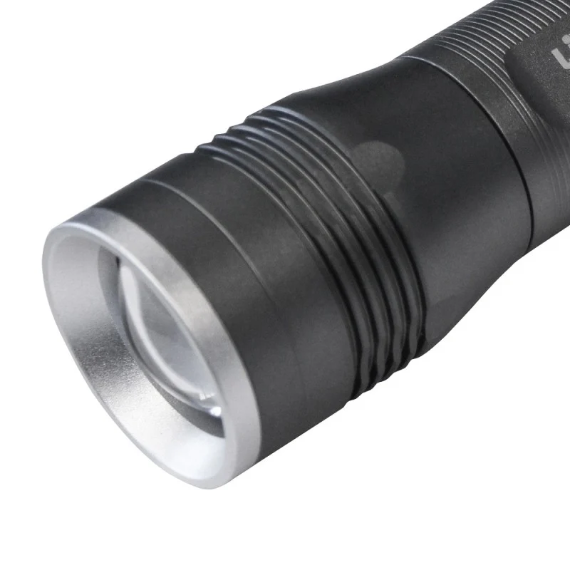Close-up of the Lighthouse Focus torch showing its front lens, silver rim and ridged head.