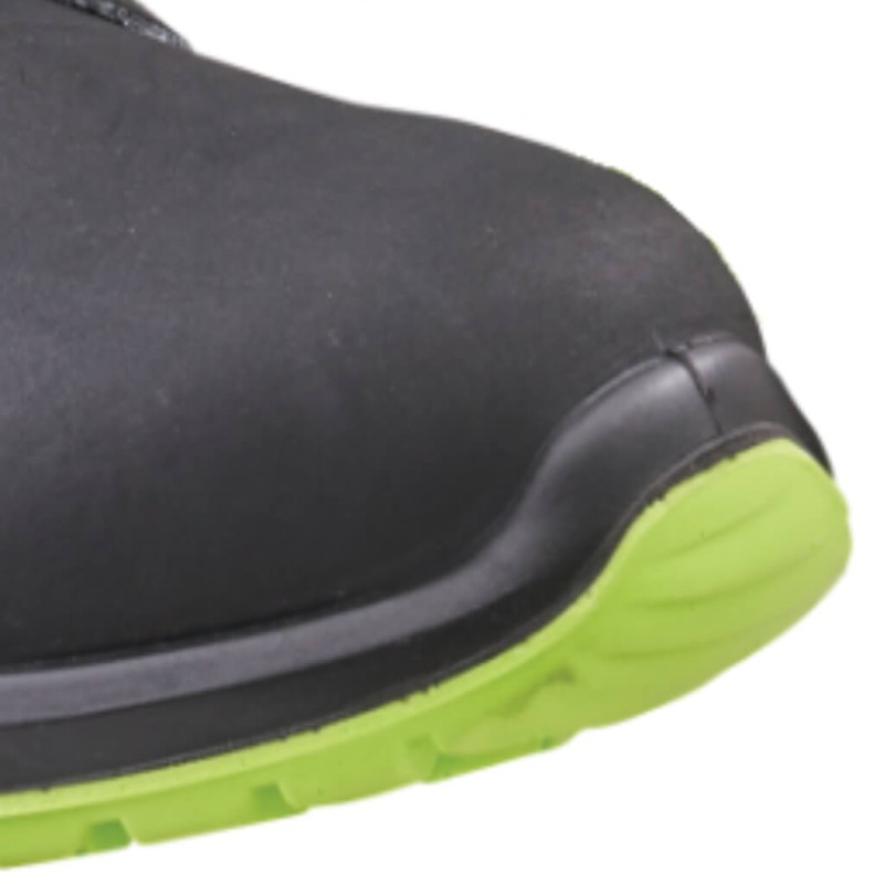 Close-up of a black work boot showing the rounded toe and green-edged outsole.