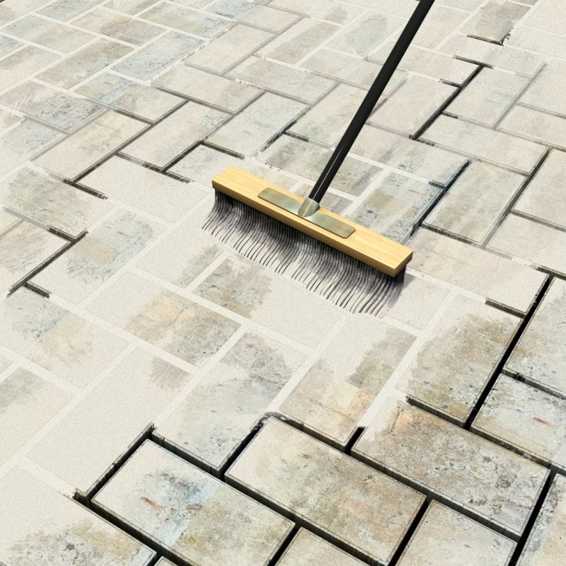 Broom removing excess Sika Block Paving Fix jointing compound from block paving